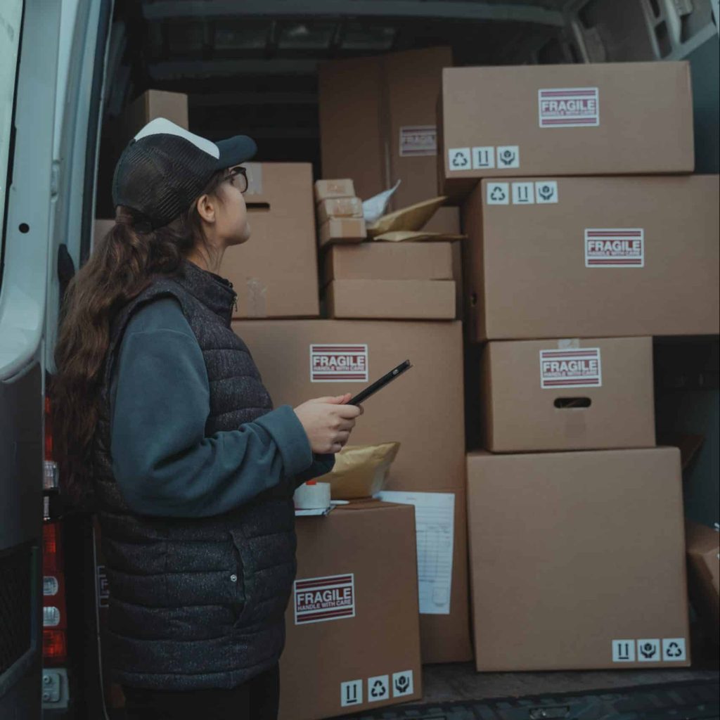 woman learning how to do stock training looking at boxes and shipping