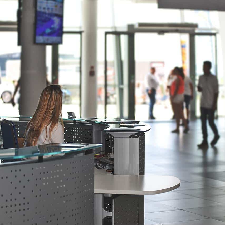 woman sitting at a desk in an airport