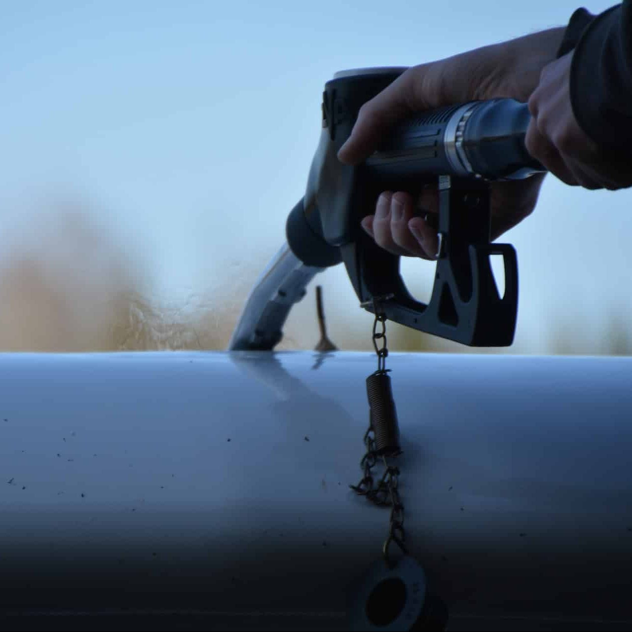 gas nozzle adding gas to an airplane