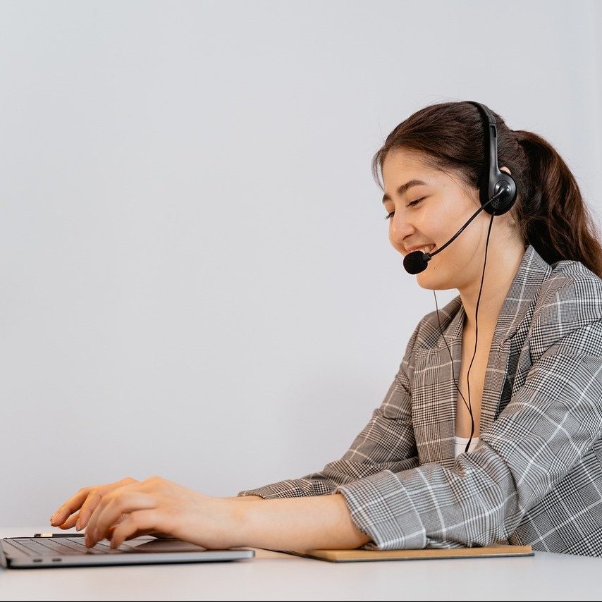 woman smiling at computer while on a call