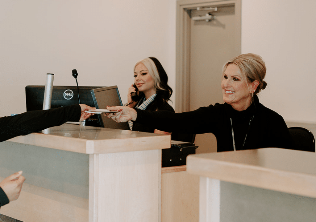 two women at desk working as a customer service agent